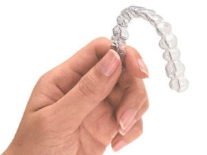Hand Holding Clear Aligner