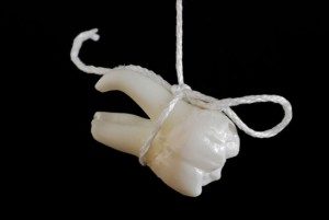 Tooth Hanging From String