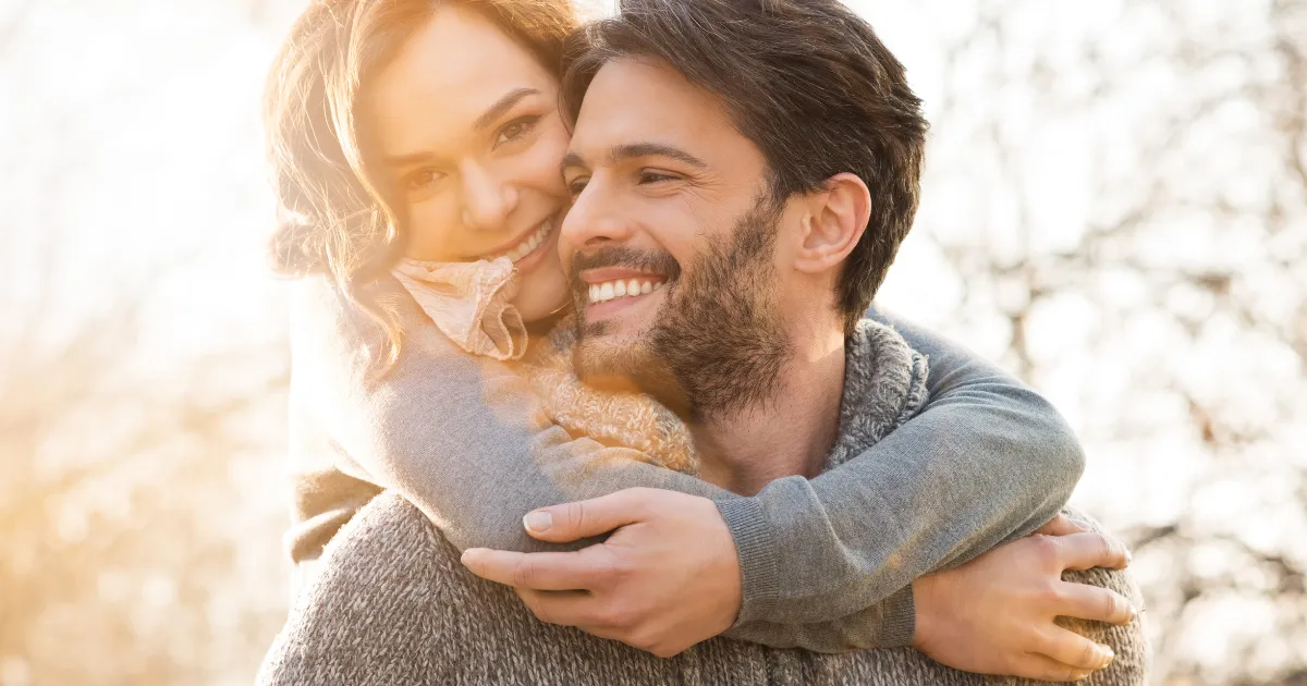 Girl Hugging Boyfriend With Perfect Smile